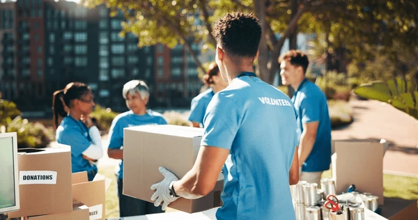 Volunteers distributing supplies, community outreach, people helping others.